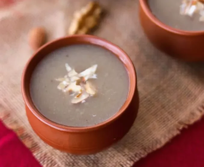 Traditional Rajasthani Bajra Raab made with pearl millet flour, ghee and jaggery served in an earthen bowl