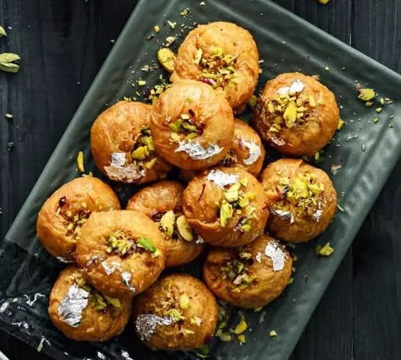 Traditional Rajasthani Balushahi sweet glazed with sugar syrup served on a festive plate
