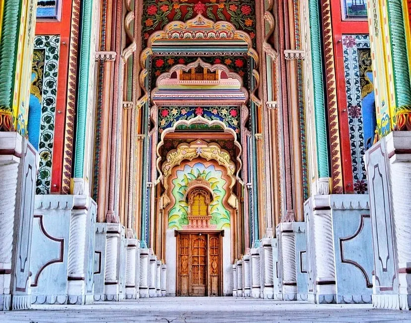 colourful stripped and patterned boulders with a gate in between